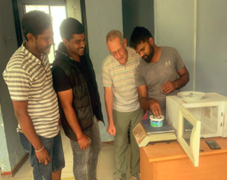 Gary Ruegsegger, second from the right, teaching new techniques to Sri Lankan dairy farmers